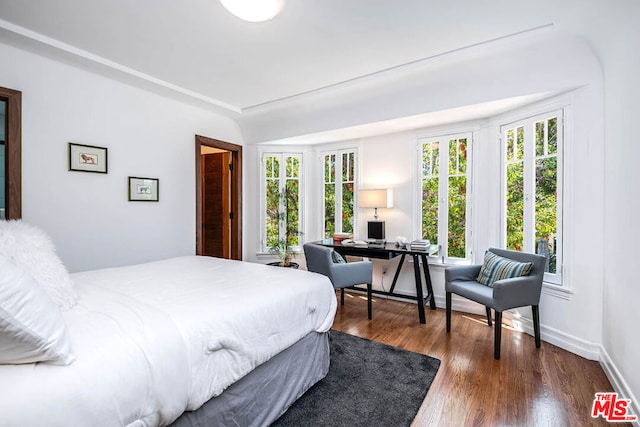 bedroom with dark wood-type flooring