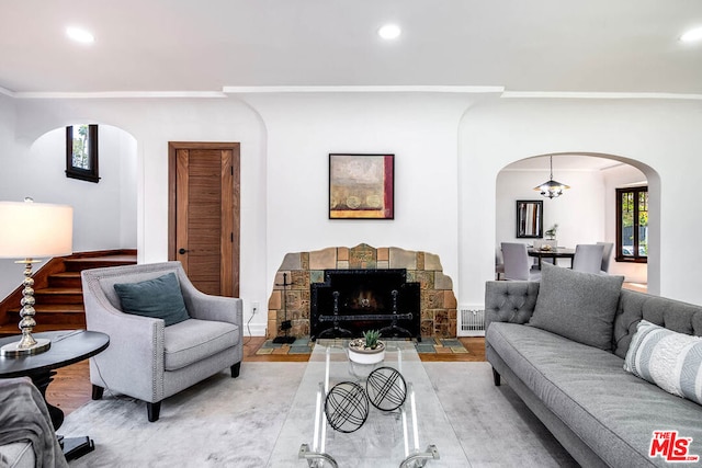 living room featuring a chandelier and a fireplace