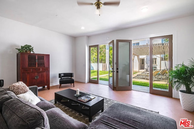 living room featuring ceiling fan and concrete floors