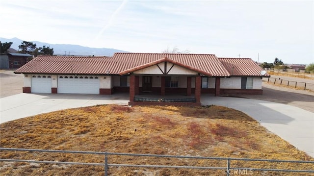 view of front facade featuring a garage and a mountain view