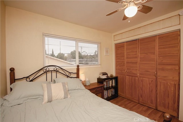 bedroom featuring a closet, hardwood / wood-style flooring, and ceiling fan