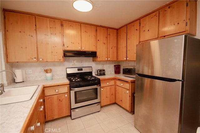 kitchen featuring light tile patterned floors, stainless steel appliances, decorative backsplash, and sink