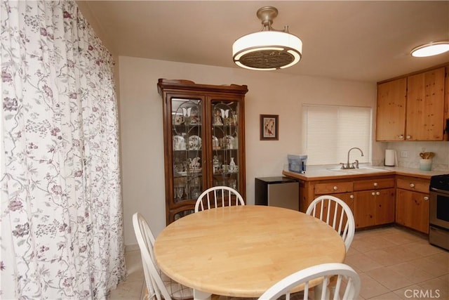 dining room featuring light tile patterned floors and sink