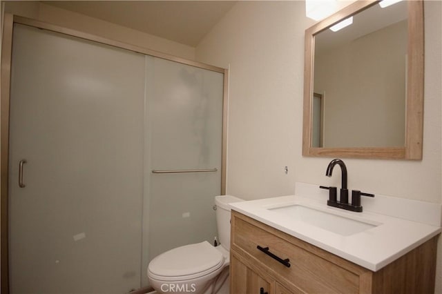 bathroom featuring toilet, walk in shower, and vanity