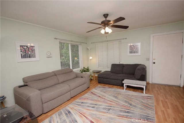 living room featuring ceiling fan, hardwood / wood-style floors, and ornamental molding