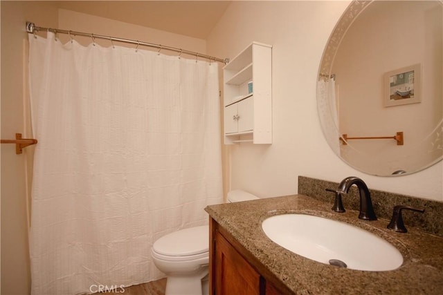 bathroom with hardwood / wood-style floors, toilet, and vanity