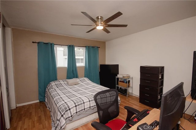 bedroom with ceiling fan and light wood-type flooring