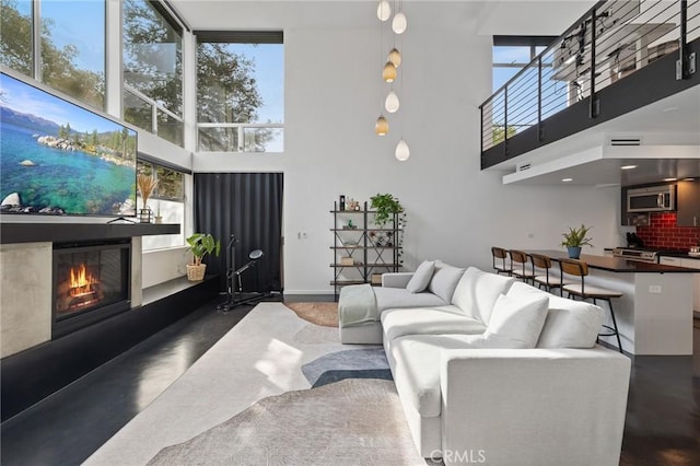 living room featuring a healthy amount of sunlight and a high ceiling