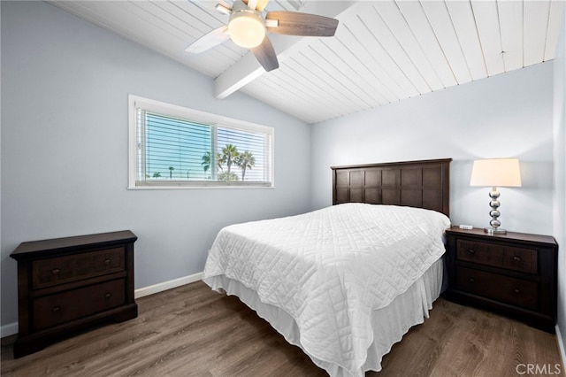 bedroom with ceiling fan, dark hardwood / wood-style floors, and vaulted ceiling with beams