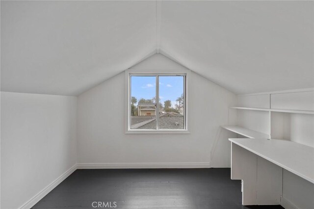 bonus room featuring dark hardwood / wood-style flooring and vaulted ceiling