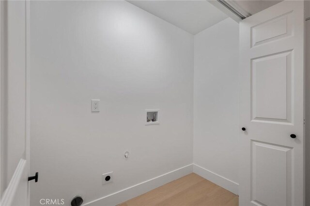 laundry room featuring hookup for a washing machine, wood-type flooring, and electric dryer hookup