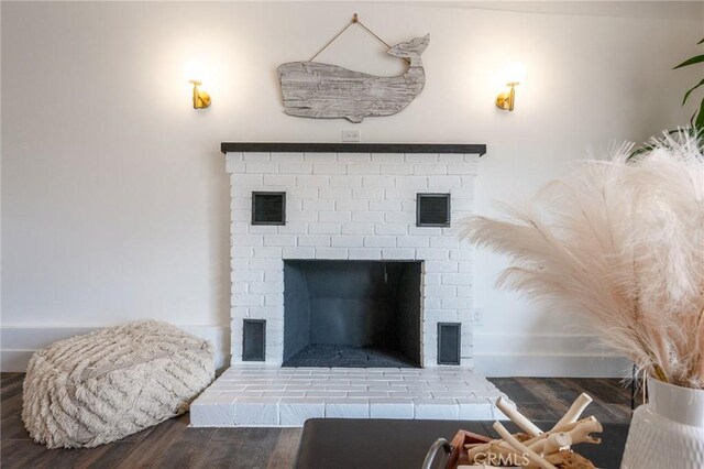 room details featuring wood-type flooring and a brick fireplace