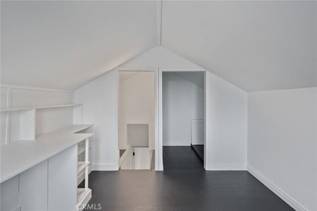 bonus room featuring lofted ceiling and dark hardwood / wood-style floors