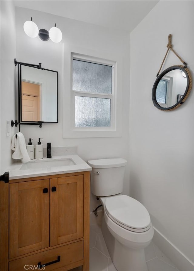 bathroom featuring tile patterned floors, vanity, and toilet