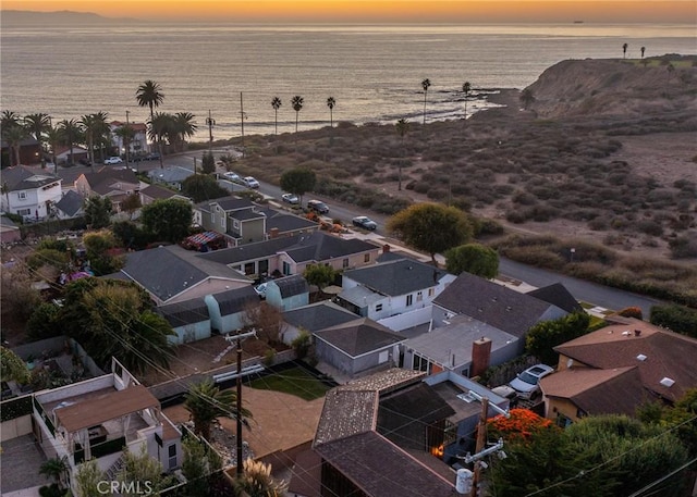 aerial view at dusk with a water view