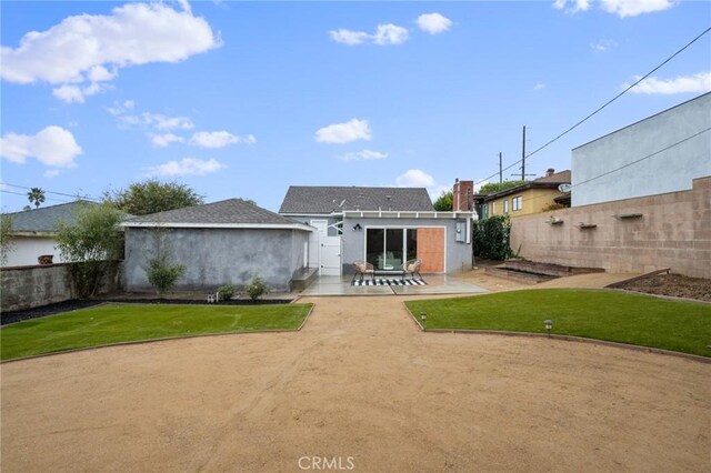 rear view of property with a patio area and a yard