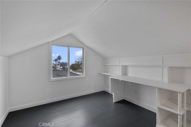 bonus room with dark hardwood / wood-style floors and lofted ceiling