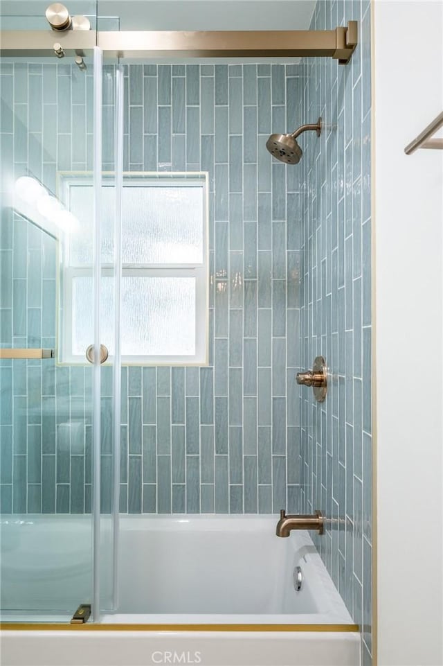 bathroom featuring shower / bath combination with glass door