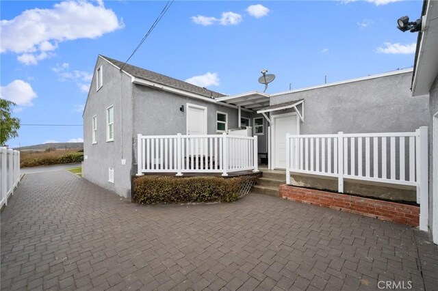 rear view of property featuring a patio