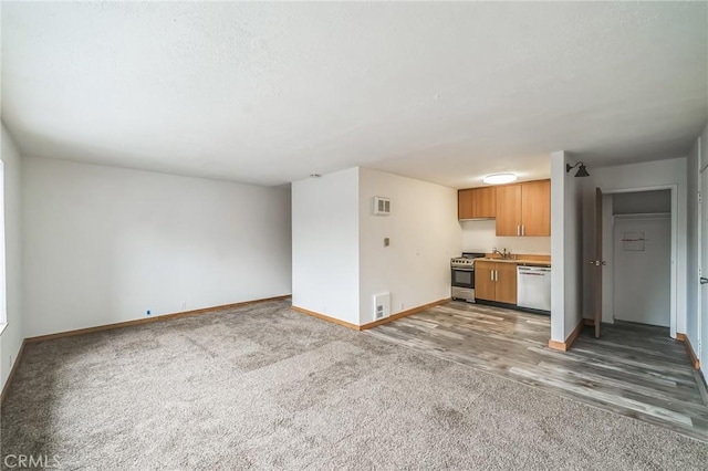 unfurnished living room with dark colored carpet and sink