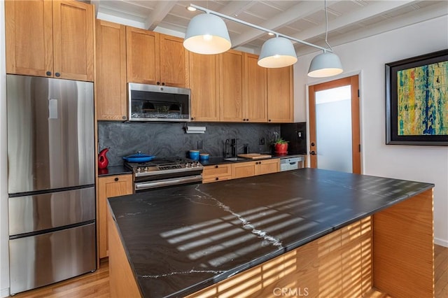 kitchen with stainless steel appliances, backsplash, pendant lighting, light hardwood / wood-style flooring, and beamed ceiling