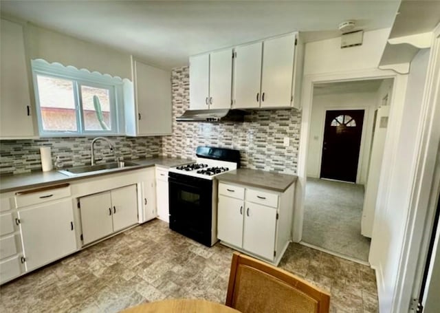 kitchen with tasteful backsplash, sink, range with gas cooktop, and white cabinets