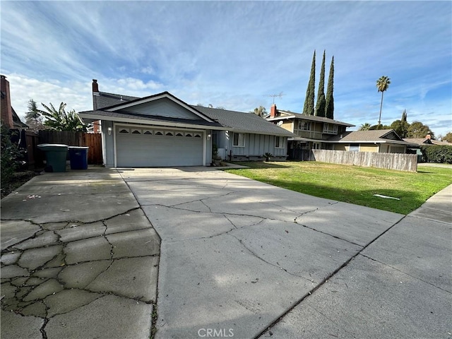 view of front of house with a garage and a front yard