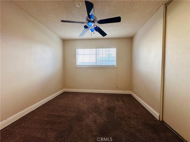 unfurnished room featuring carpet floors, a textured ceiling, and ceiling fan