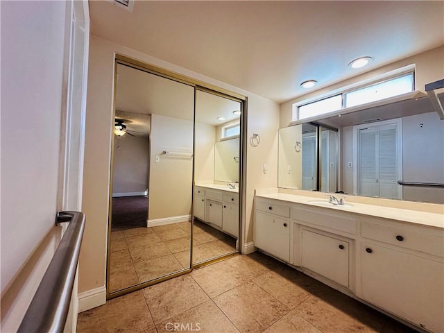 bathroom with ceiling fan and vanity