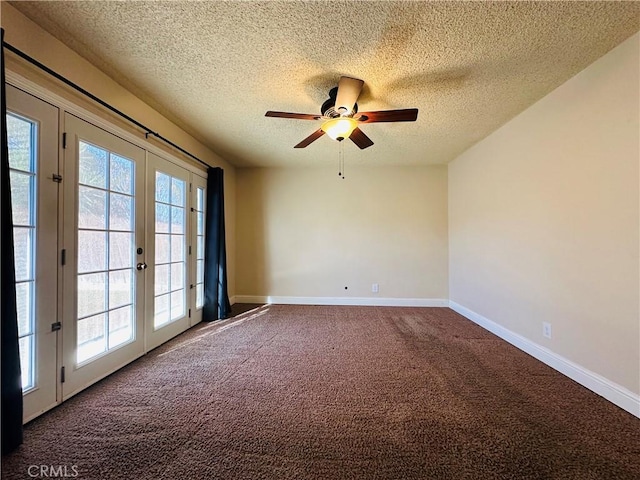 carpeted spare room with ceiling fan, french doors, and a textured ceiling