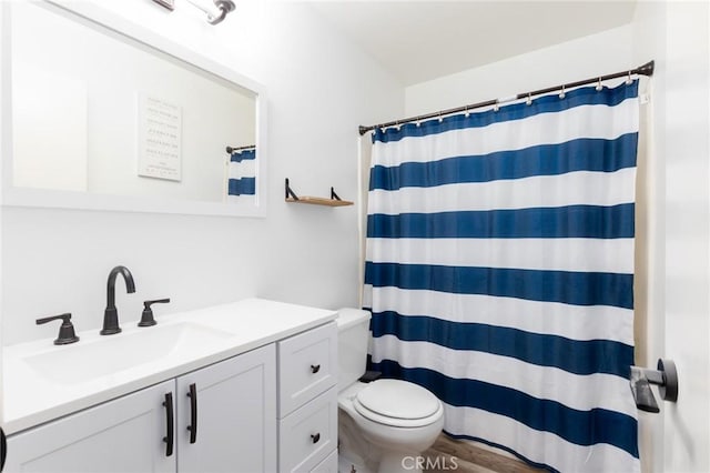 bathroom with wood-type flooring, toilet, vanity, and a shower with shower curtain