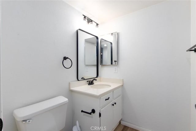 bathroom with toilet and vanity