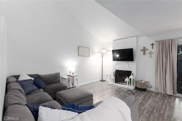 living room with lofted ceiling, a fireplace, and wood-type flooring