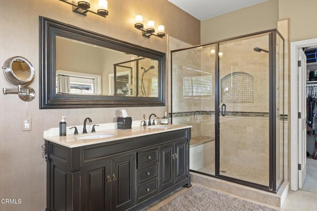 bathroom featuring walk in shower and vanity