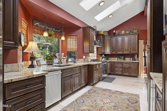 kitchen featuring appliances with stainless steel finishes, dark brown cabinets, lofted ceiling with skylight, pendant lighting, and sink