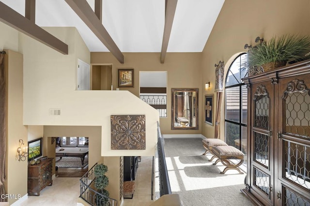 entryway featuring beam ceiling, french doors, and a towering ceiling