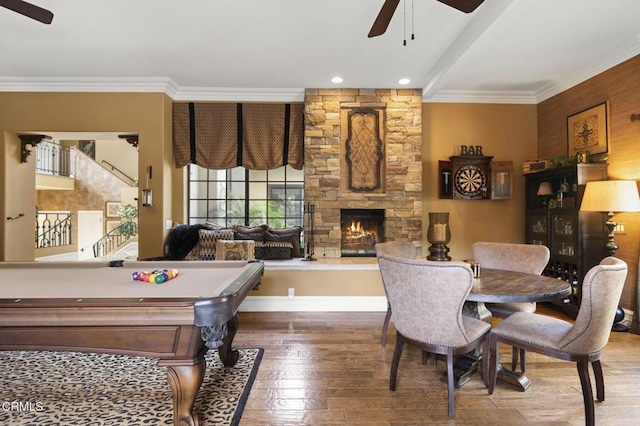 playroom with hardwood / wood-style flooring, ceiling fan, pool table, a fireplace, and crown molding