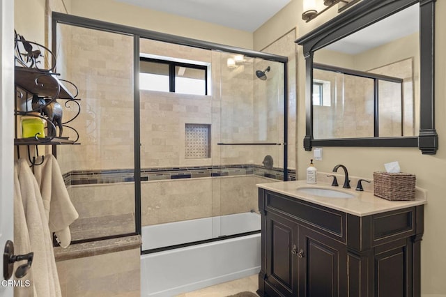 bathroom featuring vanity and shower / bath combination with glass door