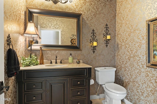 bathroom featuring toilet and vanity