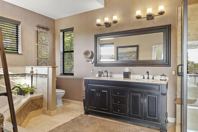 full bathroom with toilet, vanity, plus walk in shower, and tile patterned flooring