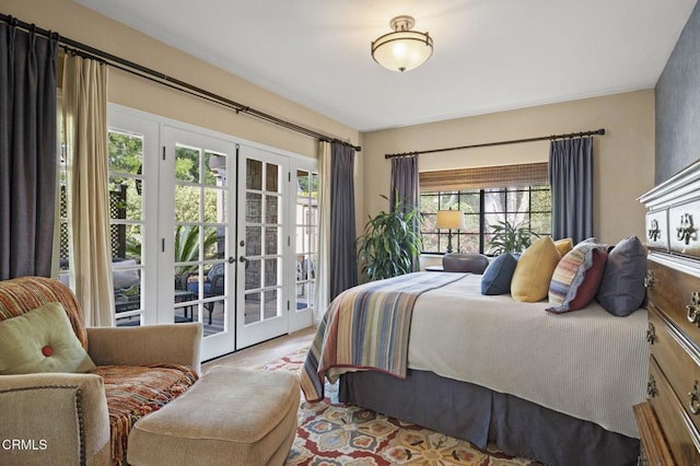 bedroom with access to exterior, multiple windows, and french doors