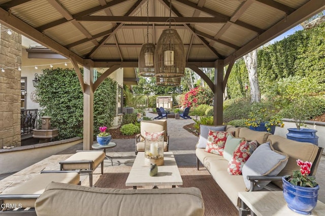 view of patio featuring central AC, a gazebo, and outdoor lounge area