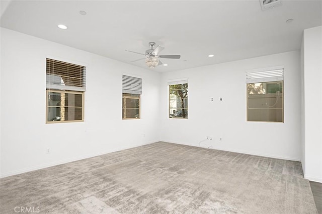 carpeted spare room with ceiling fan