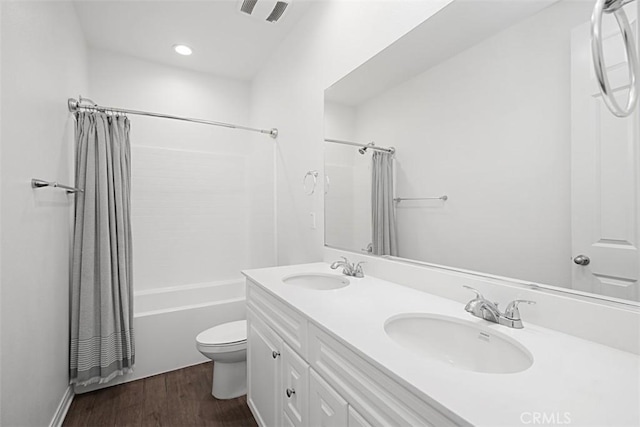 full bathroom featuring vanity, toilet, shower / bath combination with curtain, and hardwood / wood-style floors