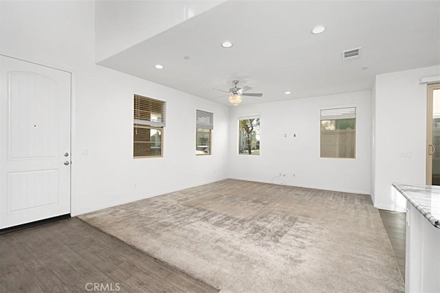 interior space featuring dark wood-type flooring and ceiling fan