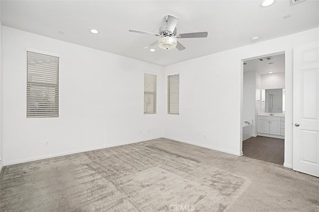 carpeted spare room with ceiling fan