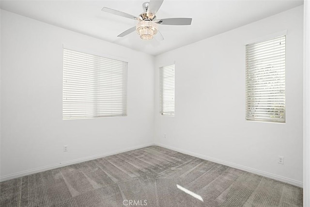 unfurnished room featuring ceiling fan and carpet flooring