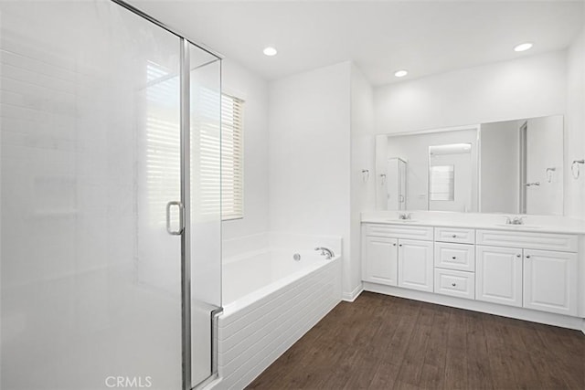 bathroom featuring vanity, hardwood / wood-style flooring, and separate shower and tub