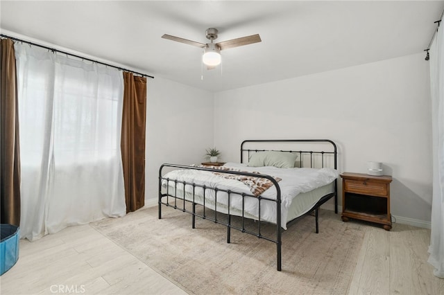 bedroom featuring ceiling fan and light hardwood / wood-style flooring