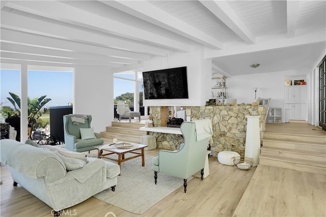 living room with beamed ceiling and light hardwood / wood-style flooring